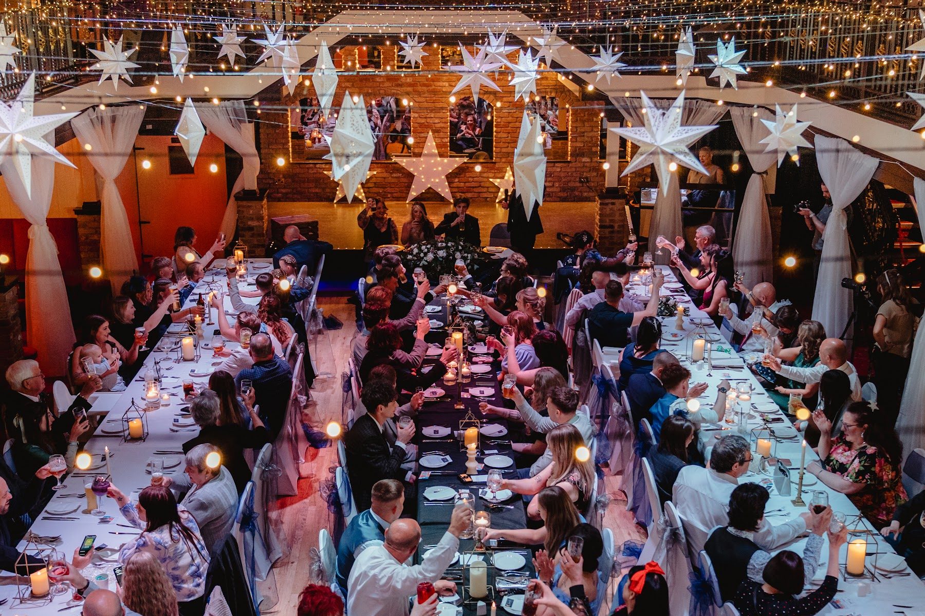 Guests seated along the long tables for the wedding breakfast
