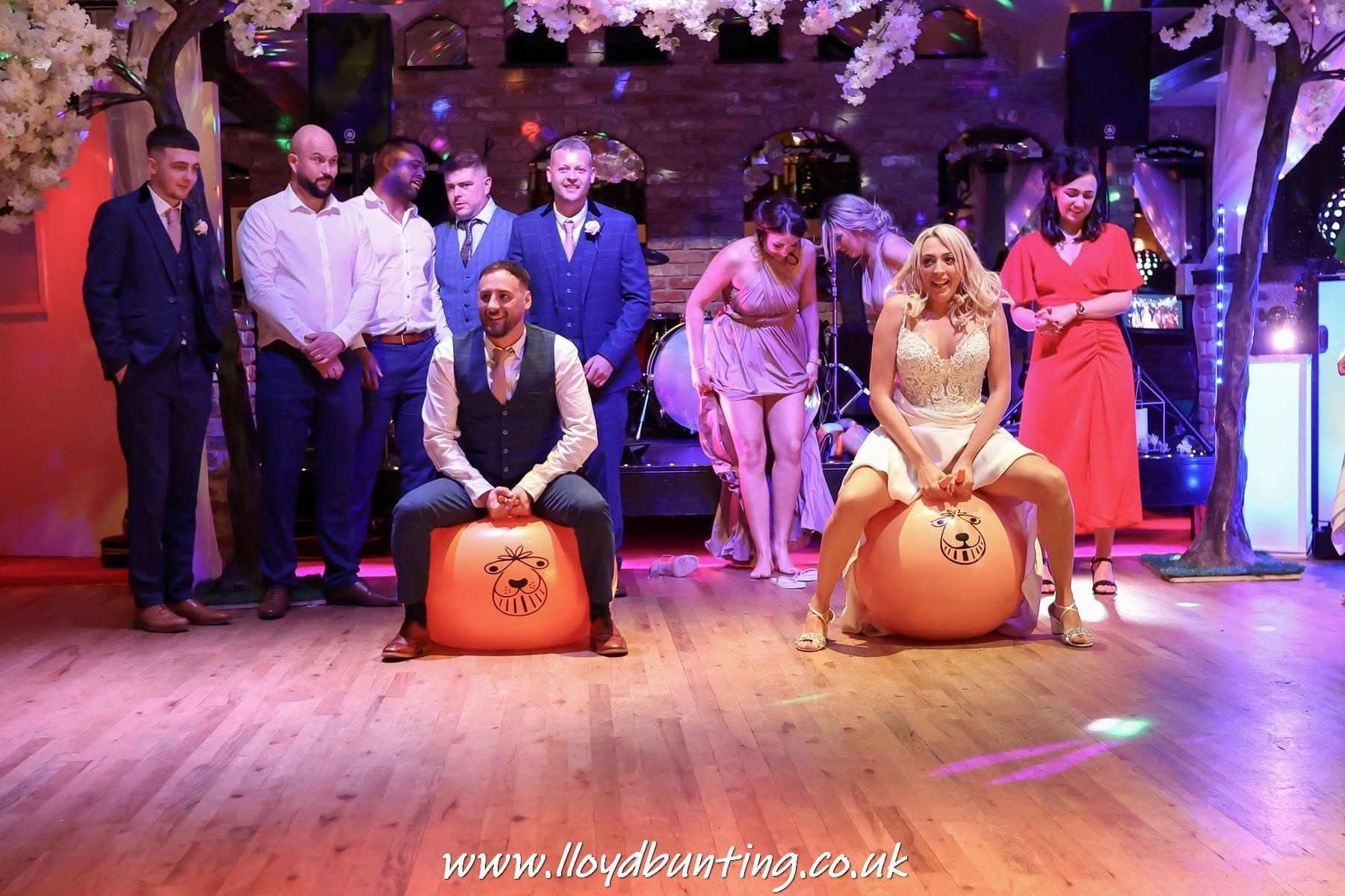 Guests racing on space hoppers across the dance floor