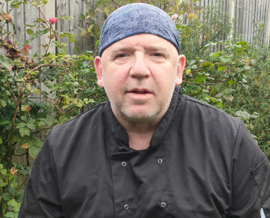 Dave, the head chef, in his chef’s jacket outside in the garden