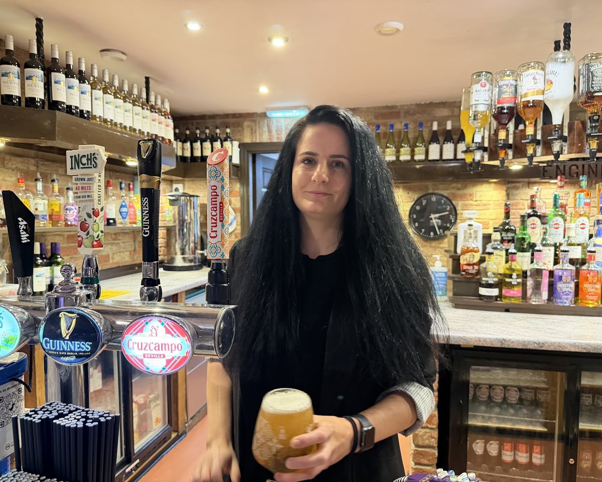 Emma, the bar manager, pulling a pint behind the Engine Shed bar