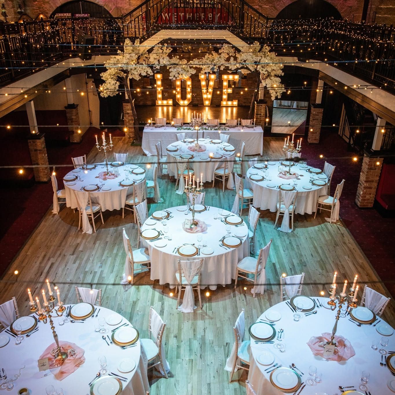 The room dressed for a wedding breakfast with illuminated LOVE letters