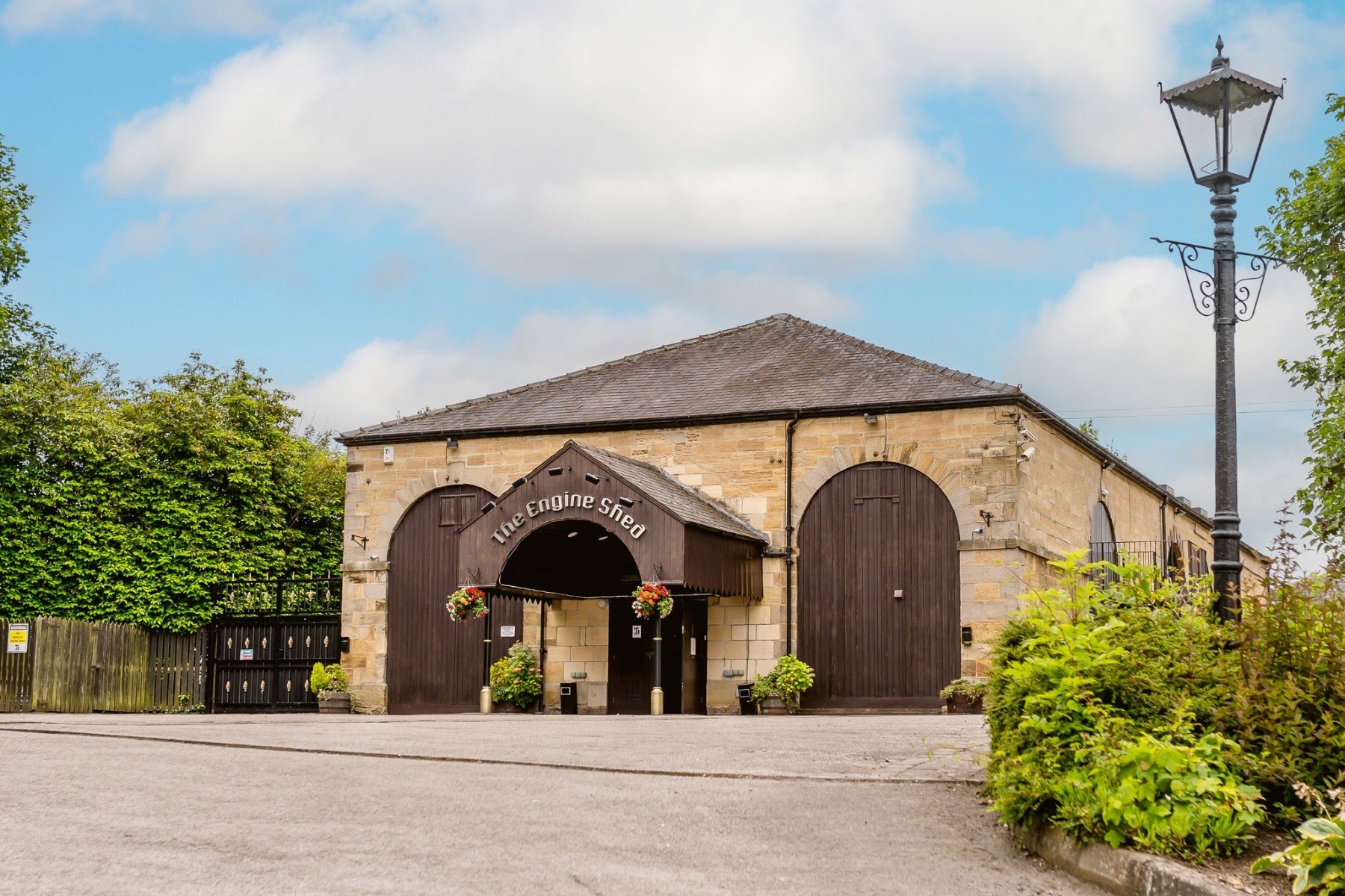 The Grade II listed Engine Shed seen from the car park on a bright day